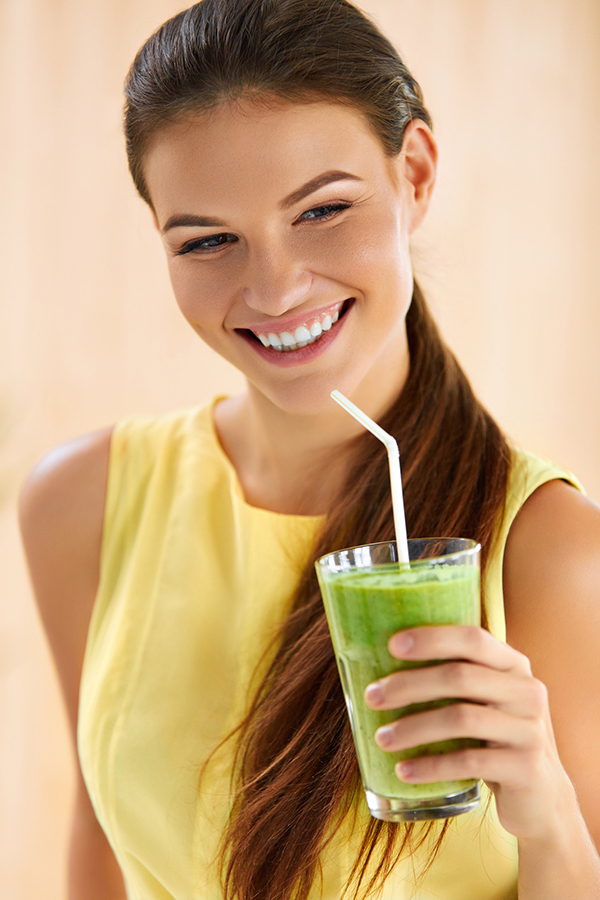 Healthy Food And Eating. Happy Young Woman Drinking Green Detox Vegetable Smoothie. Healthy Lifestyle, Vegetarian Diet And Meal. Drink Juice. Health Care And Beauty Concept.